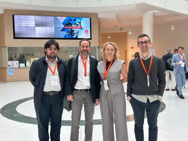 trzech mężczyzn i jedna kobieta wewnątrz dużej sali