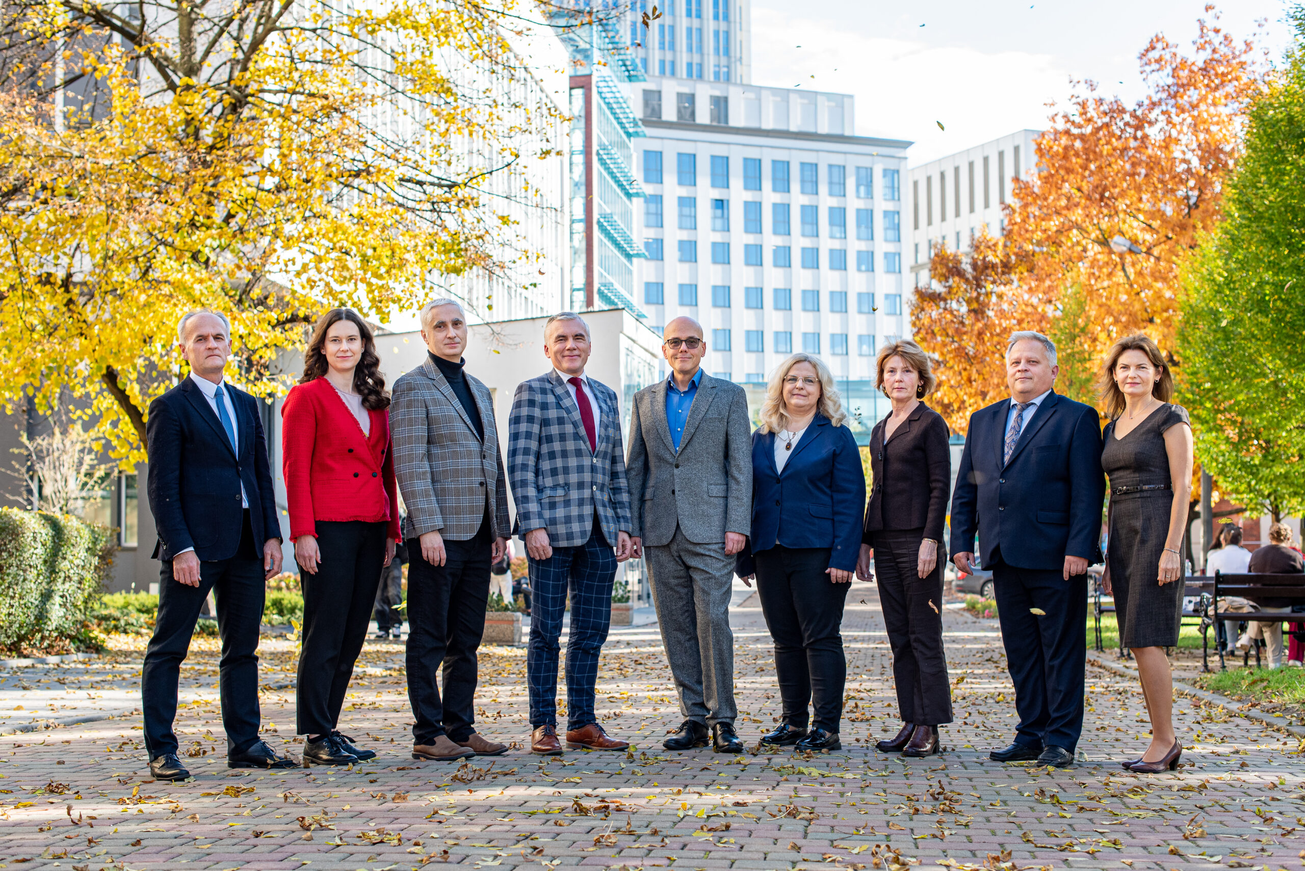 Group of people standing on the background of KUE campus